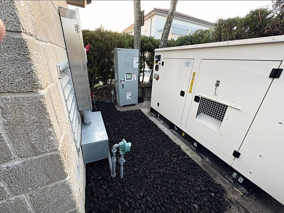 Standby generator, automatic transfer switch and gas piping installed beside a building