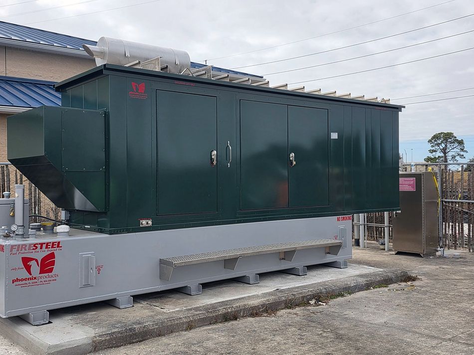 Large enclosed standby generator on a sub-base fuel tank outside a commercial building